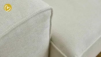 Deteilaufnahme eines weißen Sofa-Stoffes, mit erkennbarem Saum und Naht